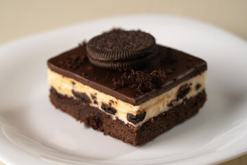 Layered chocolate cake with cookies, cream, and rich chocolate glaze