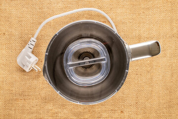 One milk frother, close-up, top view on jute cloth. © Oleksandr