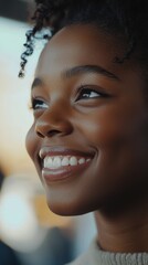 Smiling woman with curly hair in natural light, joyful and confident expression. Happiness and positivity concept
