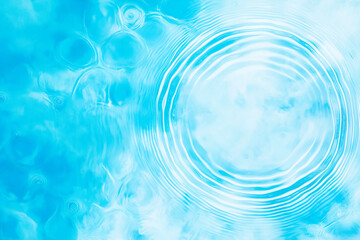 Ripples create mesmerizing patterns on a light blue background, showcasing the beauty of clear water motion in a serene and isolated setting