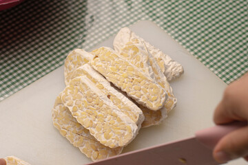 Stack the tempeh slices. Traditional food from fermented soybeans becomes tempeh.