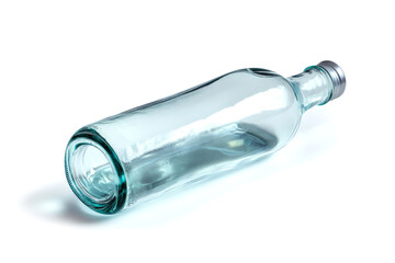 Empty light blue glass bottle lying on a white background
