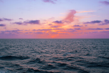 Fototapeta premium Serene Sunset Over Calm Ocean Waves with Colorful Sky 