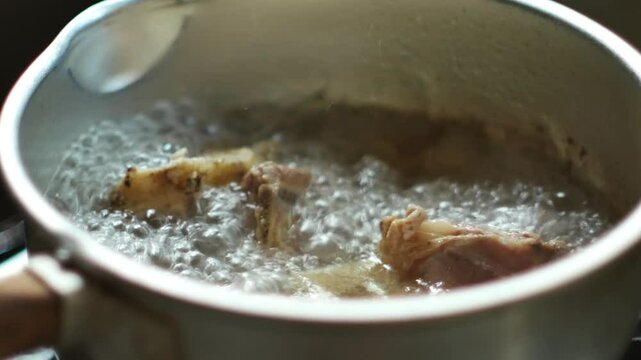 Boil soup with beef bones. Video of boiling meat to prepare as a food seasoning. 4k.