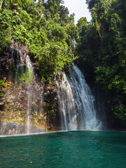 Fototapeta premium Rainbow over green plunge pool. Tinago Falls. Lanao del Norte. Philippines.
