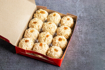 Moa is a traditional Bengali sweet made of puffed rice, jaggery, and coconut, often shaped into small, round balls.