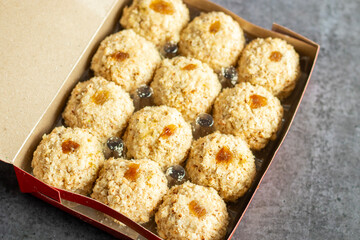Moa is a traditional Bengali sweet made of puffed rice, jaggery, and coconut, often shaped into small, round balls.