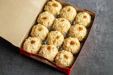 Moa is a traditional Bengali sweet made of puffed rice, jaggery, and coconut, often shaped into small, round balls.