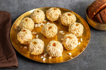 Moa is a traditional Bengali sweet made of puffed rice, jaggery, and coconut, often shaped into small, round balls.