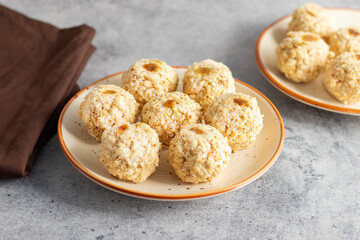 Moa is a traditional Bengali sweet made of puffed rice, jaggery, and coconut, often shaped into small, round balls.