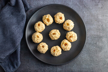 Moa is a traditional Bengali sweet made of puffed rice, jaggery, and coconut, often shaped into small, round balls.