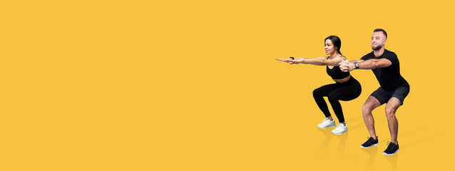 Two individuals are engaged in synchronized squats, showcasing proper form and teamwork. The bright yellow background enhances their focused expressions, creating an energetic atmosphere.