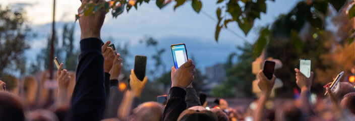 People take pictures on phone during protest in city, political uprising