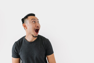 Surprised wow face Asian freelance man bun hair in black on white.