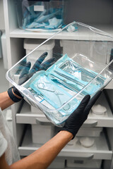 Lot of different medical tools in heat-sealing packages in container