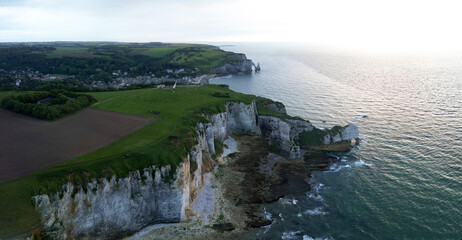 Aerial view of the famous white limestone cliffs near Etretat during sunset, France