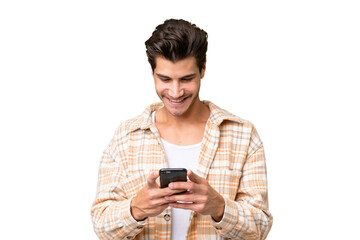 Young handsome caucasian man over isolated background sending a message with the mobile
