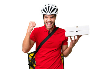 Pizza delivery man with work uniform picking up pizza boxes over isolated background celebrating a...