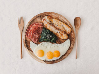 High protein keto diet breakfast meal of fish ham spinach and eggs.