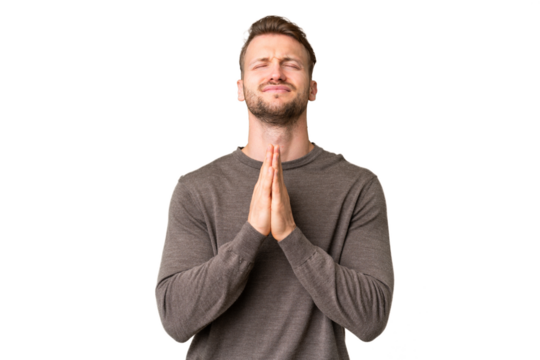 Young handsome caucasian man over isolated chroma key background keeps palm together. Person asks for something