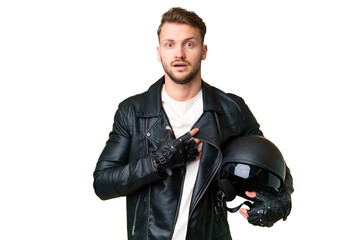 Young caucasian man with a motorcycle helmet over isolated chroma key background surprised and shocked while looking right