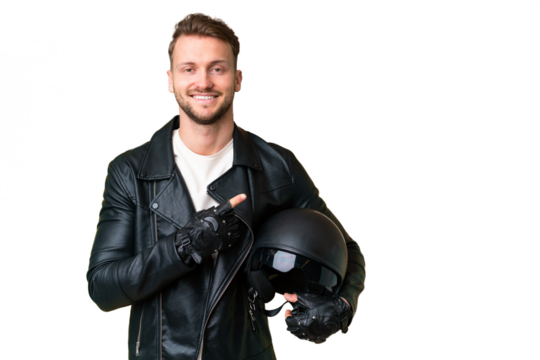 Young caucasian man with a motorcycle helmet over isolated chroma key background pointing to the side to present a product