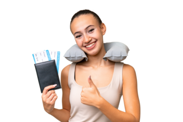 Young Arab woman with Inflatable Travel Pillow over isolated background giving a thumbs up gesture