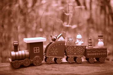 A toy Christmas train with toys. Sepia effect. Tinted image.