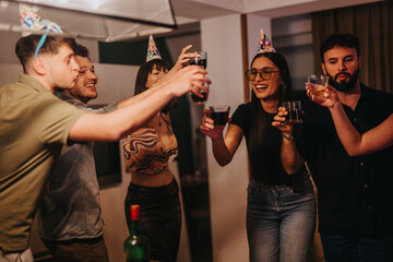 Group of friends celebrating a birthday with drinks at home