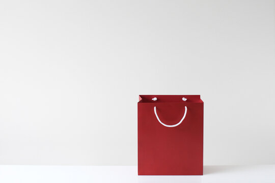 Close-up of a red Shopping bag with handles that look like a smiley face