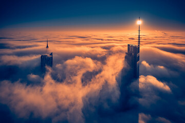 Beautiful panoramic fabulous, mesmerizing, unreal, aerial drone view of skyscrapers sticking out of low fog at sunrise, Warsaw, Poland, EU. VARSO - the tallest skyscraper in EU.