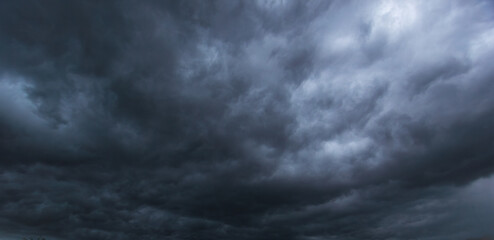 The dark sky filled with swirling clouds forebodes an approaching windstorm, showcasing the power...