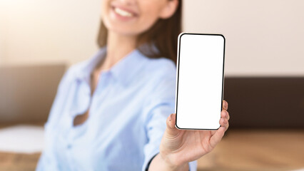 Business App. Businesswoman Showing Smartphone Blank Screen Recommending Application Sitting With Colleague In Modern Office. Selectice Focus, Mockup