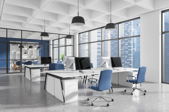 Modern office space with desks, chairs, and computers in a bright high-rise setting. 3D Rendering