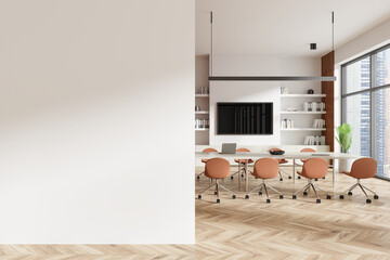 Empty wall mockup in modern office with wooden floor, meeting table, office chairs, large windows,...