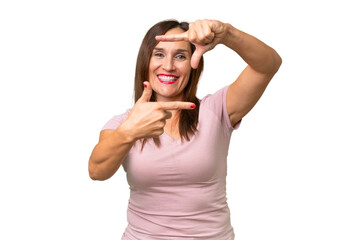 Middle-aged caucasian woman over isolated background focusing face. Framing symbol