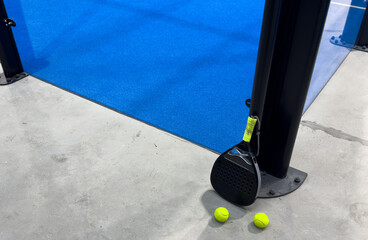 padel racket on a padel court with a ball