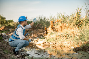 Water resources engineers inspect the quality of a canal in a community filled with garbage.
