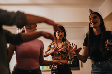 A lively group of friends are celebrating a birthday at home, enjoying music and laughter in a comfortable living room setting. The atmosphere is cheerful and festive, capturing a moment of happiness.