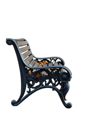 There is a black bench with a wrought iron pattern on the brick path. On a white background