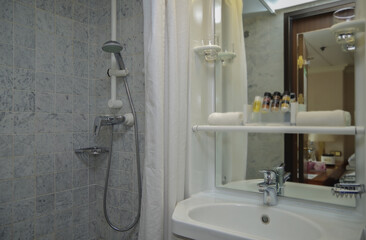 Old fashioned bathroom with sink and faucet inside dated cabin stateroom onboard historic classic...