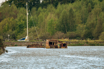 A shipwreck on the banks of the River Clyde in Bowling, Scotland, UK