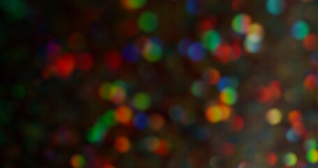 Bokeh festive. Flare sparks. Multicolor yellow green red purple flicker round gleaming blinking...