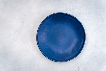 Blue plate on light gray backdrop centered