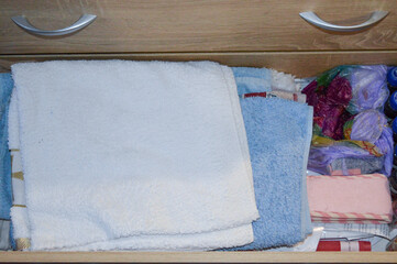 open drawer filled with clothes towels storage systems wardrobe organization or closet solutions...