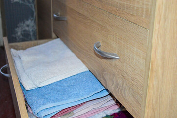 open drawer filled with clothes towels storage systems wardrobe organization or closet solutions...