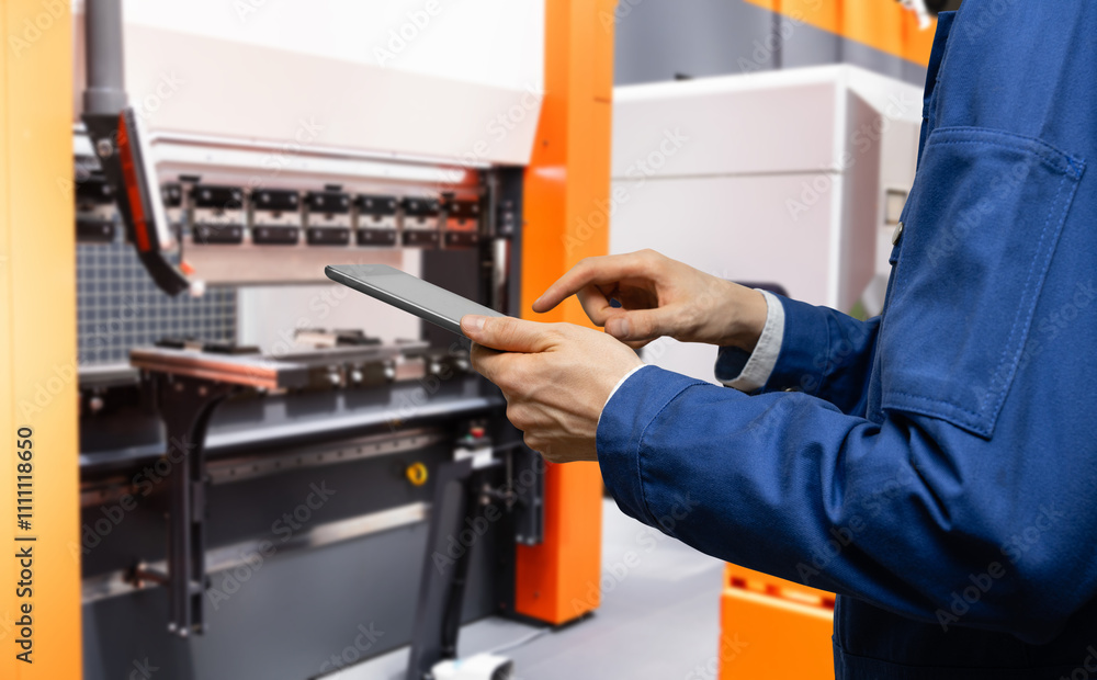 Fototapete Engineer uses a digital tablet to control robots in a smart factory. Smart industry 4.0 concept