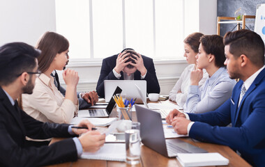 Stressed boss having problem at business meeting in office