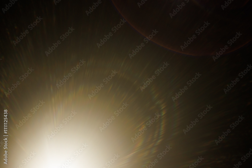 Fototapete Easy to add lens flare effects for overlay designs or screen blending mode to make high-quality images. Abstract sun burst, digital flare, iridescent glare over black background.