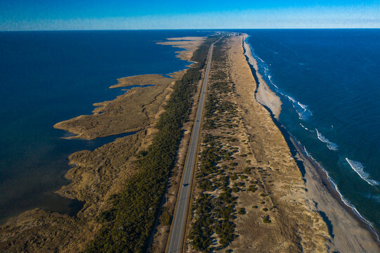 Drone aerial view of Outer Banks Highway 12 with Atlantic Ocean and Sound on both sides, Cape Hatteras National Seashore NP